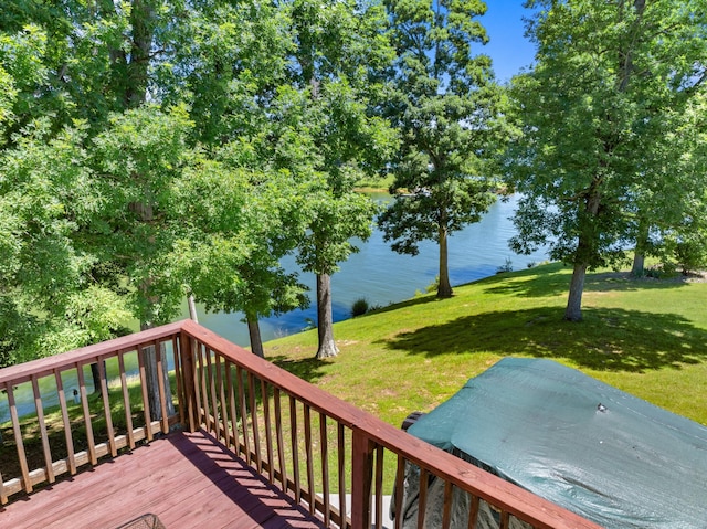 deck with a water view and a yard