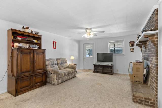 living area with ceiling fan and light carpet