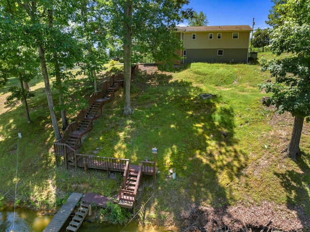 view of yard with a water view and stairs