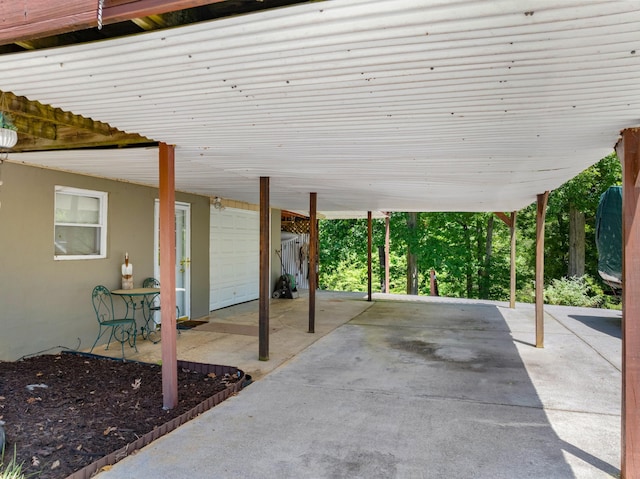 view of patio / terrace with a garage and a carport