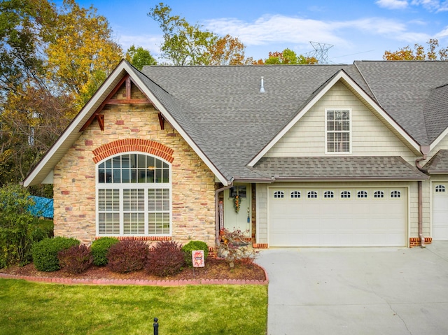 view of front of property featuring a garage and a front lawn