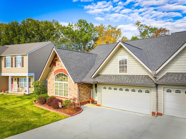 view of front of home with a front yard and a garage