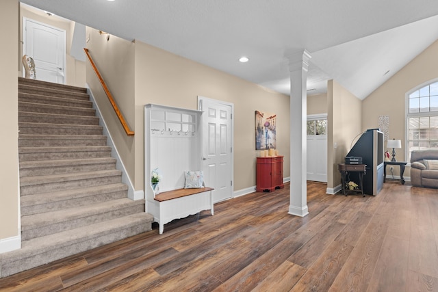 entryway featuring vaulted ceiling and dark hardwood / wood-style floors