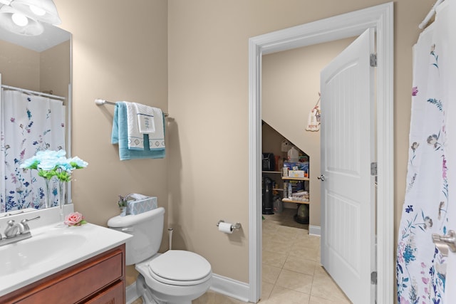 bathroom featuring tile patterned flooring, vanity, toilet, and curtained shower