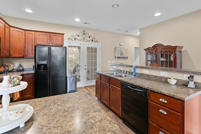 kitchen with sink, black appliances, french doors, and light hardwood / wood-style flooring