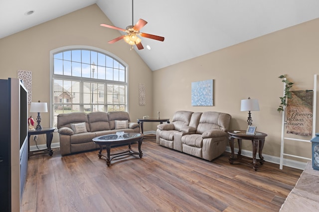 living room with ceiling fan, dark wood-type flooring, and high vaulted ceiling