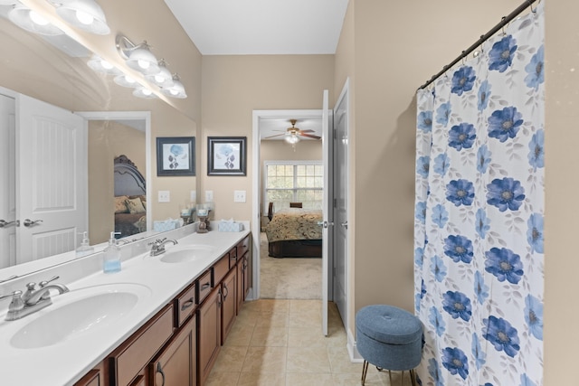 bathroom with tile patterned floors, ceiling fan, vanity, and walk in shower