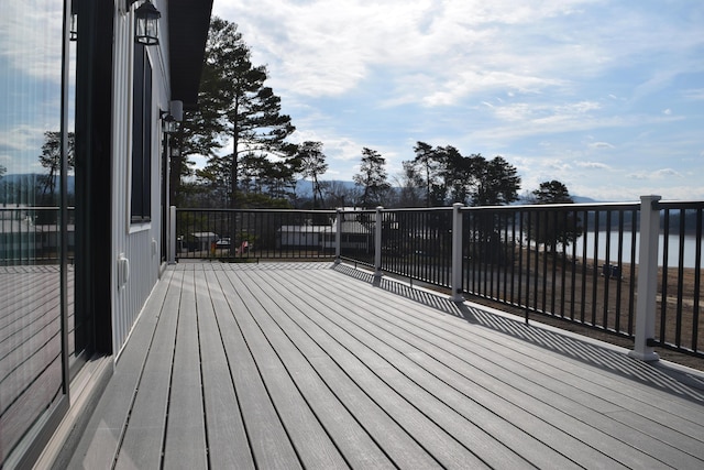 wooden terrace featuring a water view