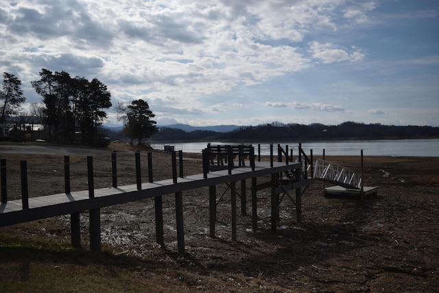 view of dock with a water and mountain view