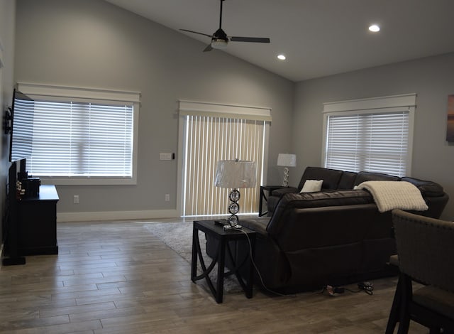 living room with ceiling fan, high vaulted ceiling, and light wood-type flooring