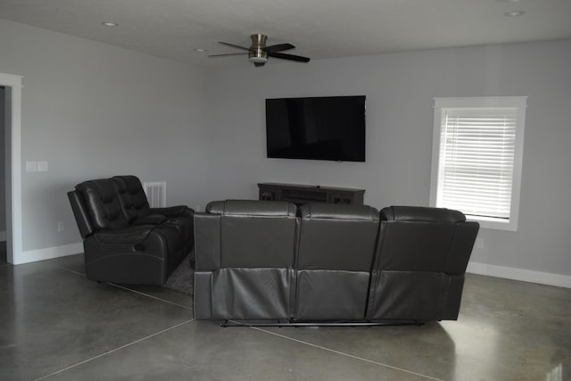 living room featuring ceiling fan and concrete floors