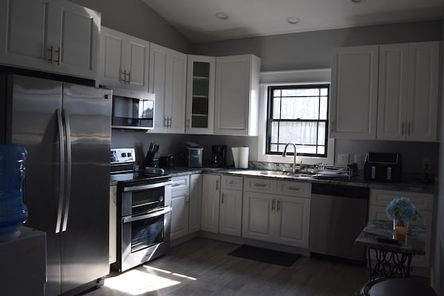 kitchen featuring stainless steel appliances, dark hardwood / wood-style floors, sink, and white cabinets