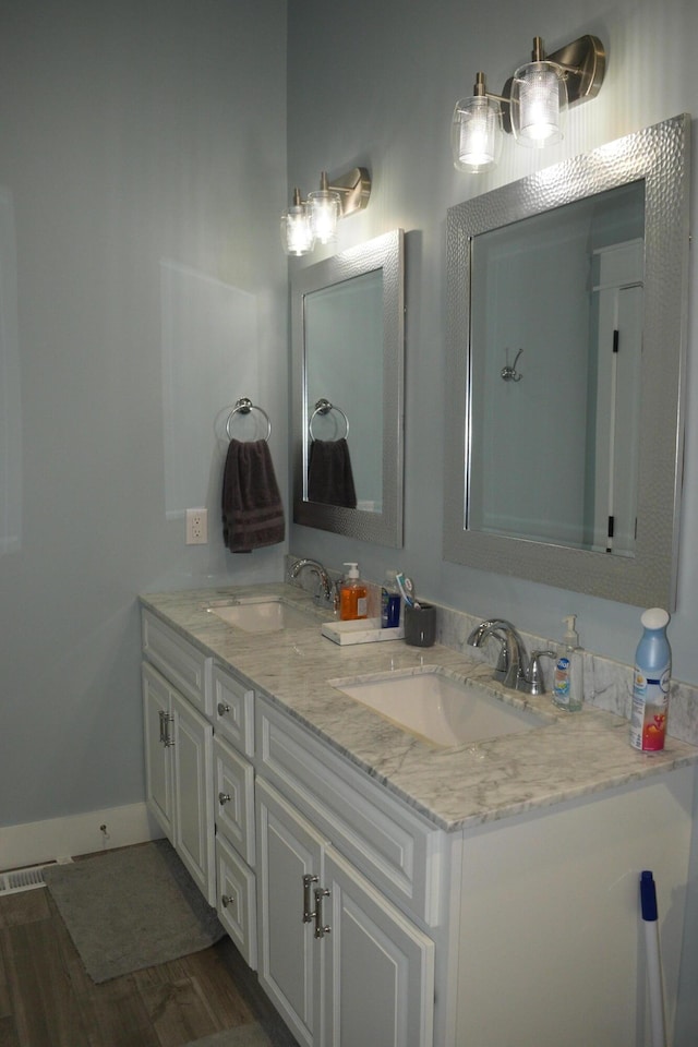 bathroom with vanity and wood-type flooring