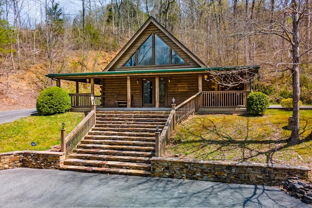 log-style house featuring a porch