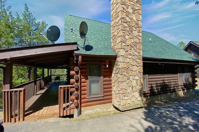 rear view of property featuring a wooden deck