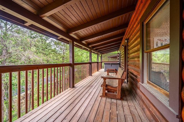 wooden deck with a hot tub