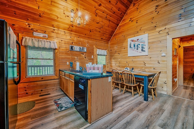 kitchen with wooden ceiling, black appliances, wooden walls, vaulted ceiling, and light hardwood / wood-style floors