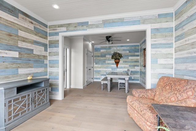 interior space featuring light hardwood / wood-style floors, ceiling fan, and crown molding