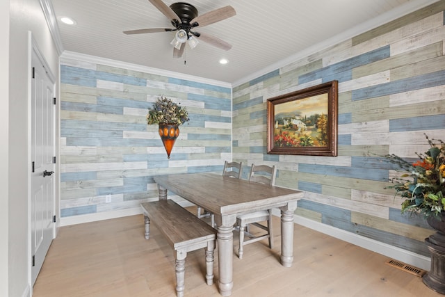 dining area with light wood-type flooring, ceiling fan, and ornamental molding