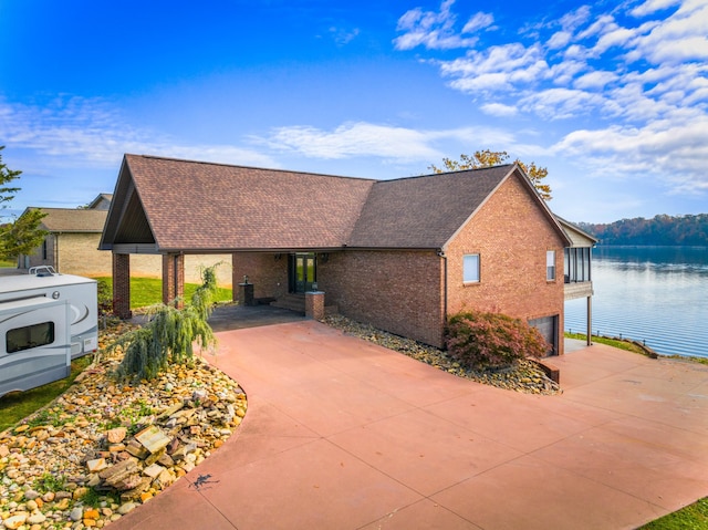 view of front of home featuring a garage and a water view