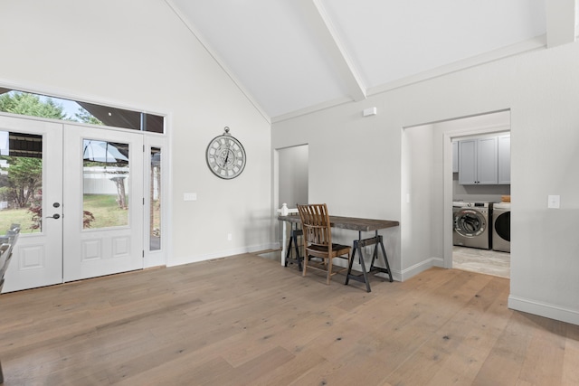 foyer entrance with beam ceiling, french doors, separate washer and dryer, high vaulted ceiling, and light wood-type flooring