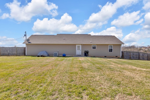 back of property featuring crawl space, a fenced backyard, a lawn, and central AC unit