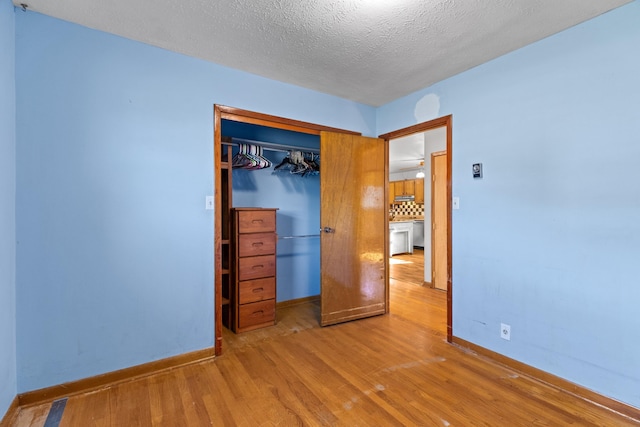 2757 Bethel Rd, Morristown, TN 37813 - unfurnished bedroom featuring wood finished floors, baseboards, a closet, and a textured ceiling