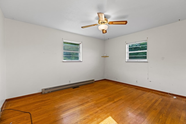 2757 Bethel Rd, Morristown, TN 37813 - empty room featuring a baseboard heating unit, plenty of natural light, light wood finished floors, and ceiling fan
