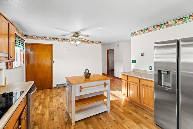 2757 Bethel Rd, Morristown, TN 37813 - kitchen featuring appliances with stainless steel finishes, light wood-style floors, a ceiling fan, and light countertops