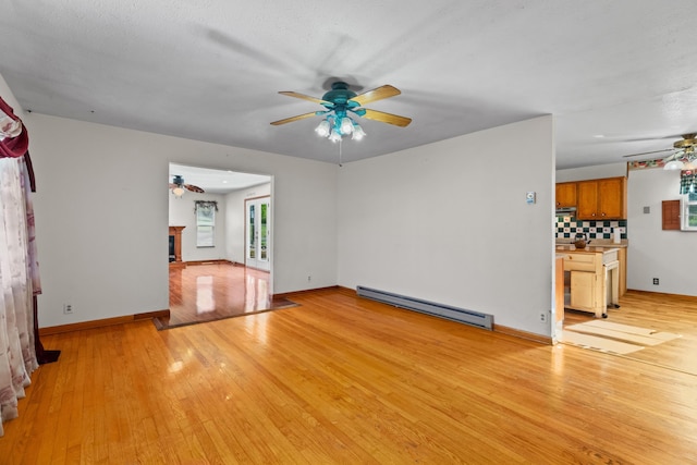 2757 Bethel Rd, Morristown, TN 37813 - unfurnished living room with ceiling fan, baseboard heating, light wood-type flooring, and baseboards