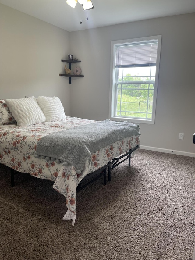 carpeted bedroom featuring a ceiling fan and baseboards