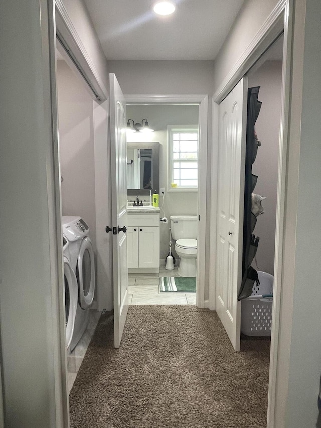 bathroom featuring toilet, vanity, and separate washer and dryer
