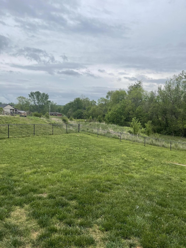 view of yard featuring fence and a rural view