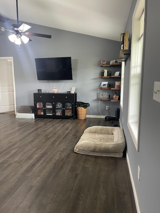 living area featuring ceiling fan, baseboards, and wood finished floors