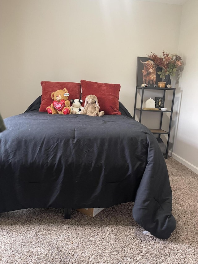 carpeted bedroom featuring baseboards