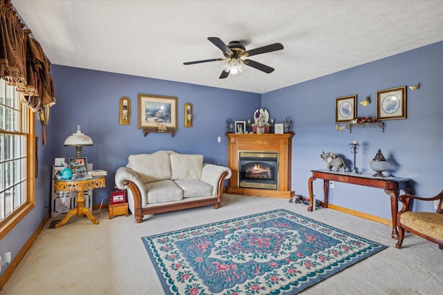 2895 Looney Rd, Parrottsville, TN 37843 - carpeted living room featuring a ceiling fan, baseboards, a glass covered fireplace, and a textured ceiling