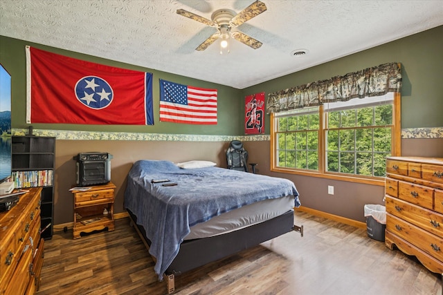 2895 Looney Rd, Parrottsville, TN 37843 - bedroom with wood finished floors, baseboards, a textured ceiling, and ceiling fan