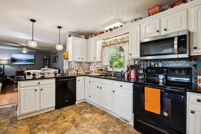 2895 Looney Rd, Parrottsville, TN 37843 - kitchen with black appliances, dark countertops, a peninsula, a sink, and a ceiling fan