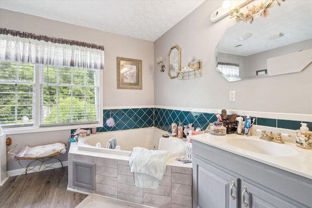 2895 Looney Rd, Parrottsville, TN 37843 - bathroom featuring vanity, wood finished floors, a tub with jets, and a textured ceiling