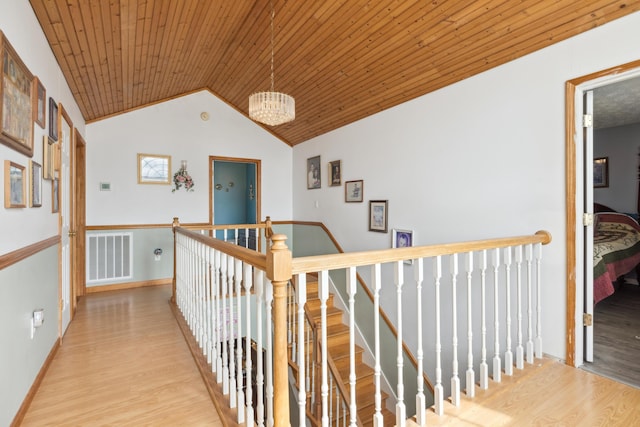 2895 Looney Rd, Parrottsville, TN 37843 - hall with an upstairs landing, wood finished floors, a chandelier, lofted ceiling, and wooden ceiling