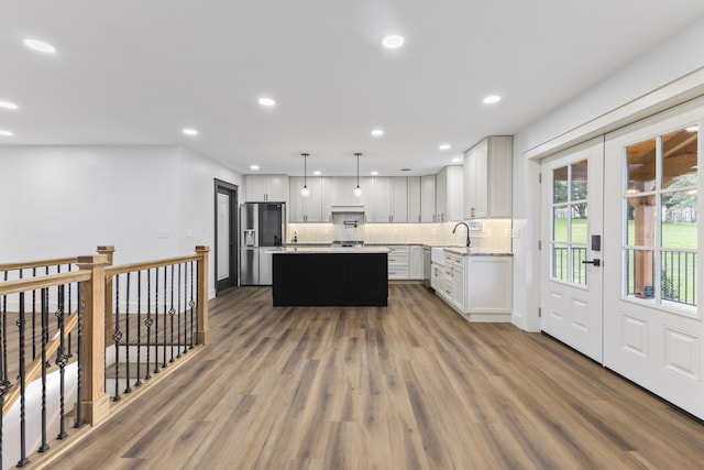 300 Victor Ln, Whitesburg, TN 37891 - kitchen featuring stainless steel refrigerator with ice dispenser, a kitchen island, backsplash, dark wood-style floors, and white cabinetry
