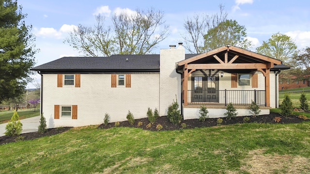 300 Victor Ln, Whitesburg, TN 37891 - rear view of house featuring brick siding, a chimney, and a lawn