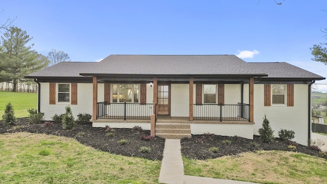 300 Victor Ln, Whitesburg, TN 37891 - view of front of house featuring covered porch, brick siding, a front lawn, and a shingled roof