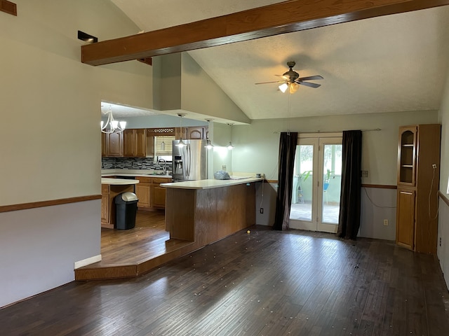 kitchen featuring kitchen peninsula, decorative backsplash, stainless steel fridge, ceiling fan with notable chandelier, and dark hardwood / wood-style floors