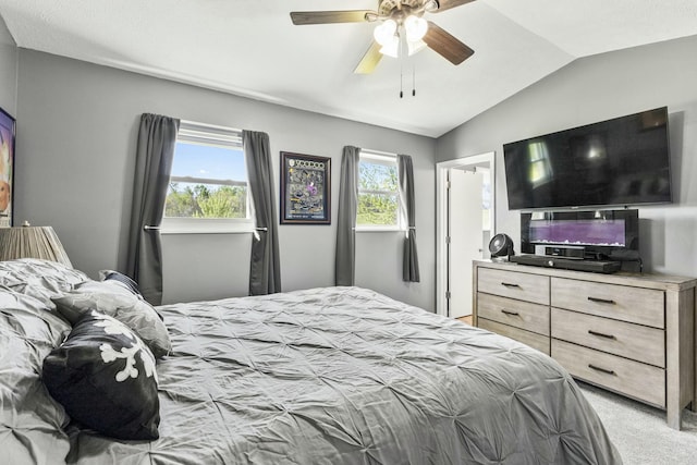 bedroom with ceiling fan, vaulted ceiling, and light carpet