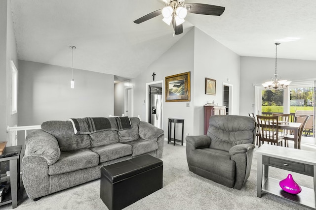 living room featuring vaulted ceiling, carpet flooring, and ceiling fan with notable chandelier