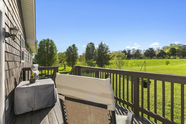 wooden terrace featuring a lawn