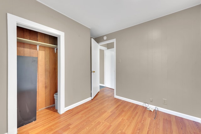 unfurnished bedroom featuring baseboards and light wood-style flooring