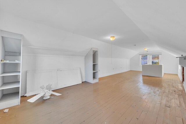 bonus room with lofted ceiling and hardwood / wood-style floors