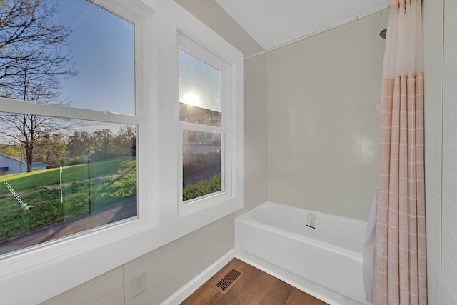 bathroom with visible vents and wood finished floors